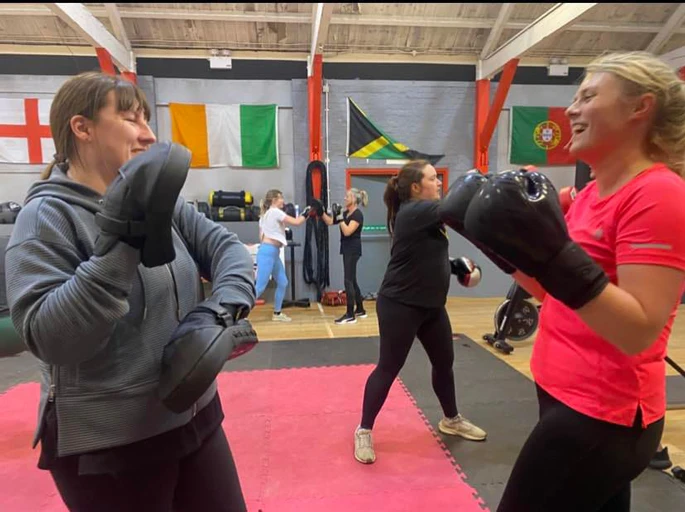 Revenge members practising boxing together on pads
